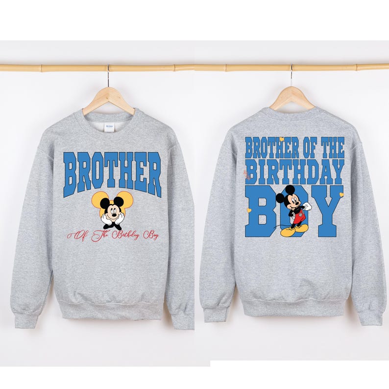 Puede incluir: Sudadera gris con un gr&aacute;fico de Mickey Mouse azul y rojo y el texto "Brother of the Birthday Boy" en la espalda. La parte delantera de la sudadera tiene el texto "Brother" en azul con un gr&aacute;fico de Mickey Mouse m&aacute;s peque&ntilde;o y el texto "Of The Birthday Boy" debajo.