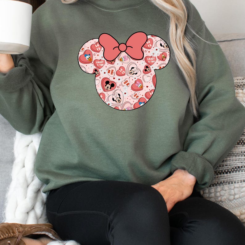 May include: A green sweatshirt with a pink and red Mickey Mouse head design. The design features hearts, Mickey Mouse and Minnie Mouse characters, and the text "Crazy 4 You".