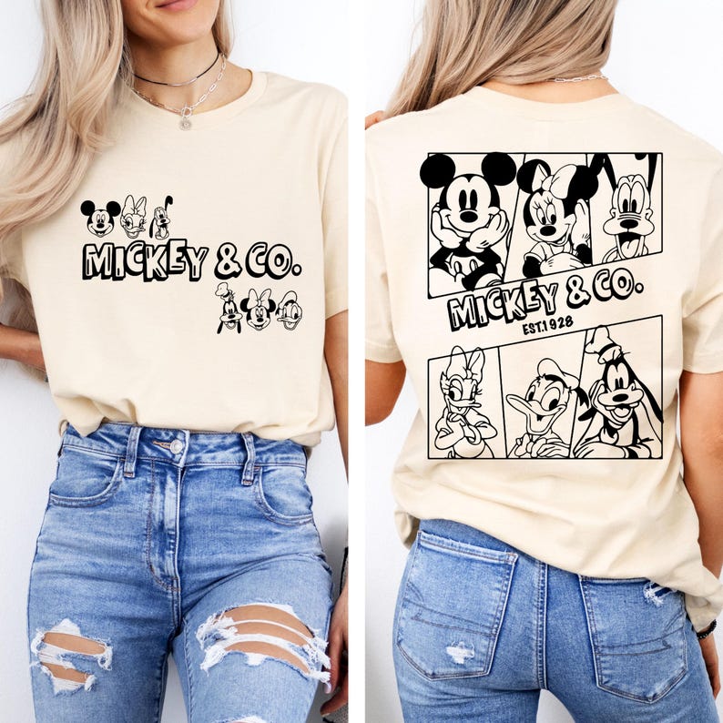 May include: A beige t-shirt with a black and white graphic print of Mickey Mouse and friends. The front of the shirt says "Mickey & Co." and the back of the shirt says "Mickey & Co. Est 1928".