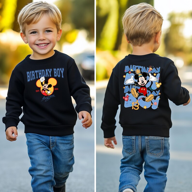 May include: Black sweatshirt with a blue and white graphic of Mickey Mouse celebrating a birthday. The text on the sweatshirt says "Birthday Boy" and "Est. 2013".