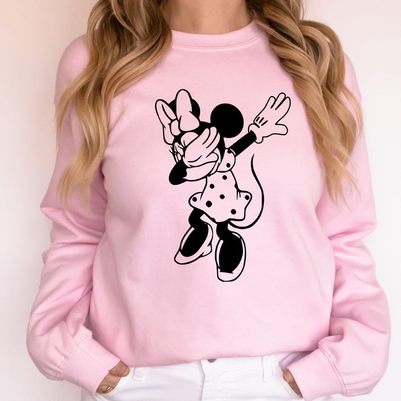 May include: A pink sweatshirt with a black graphic of a cartoon mouse doing the dab. The mouse is wearing a polka dot dress and a bow.
