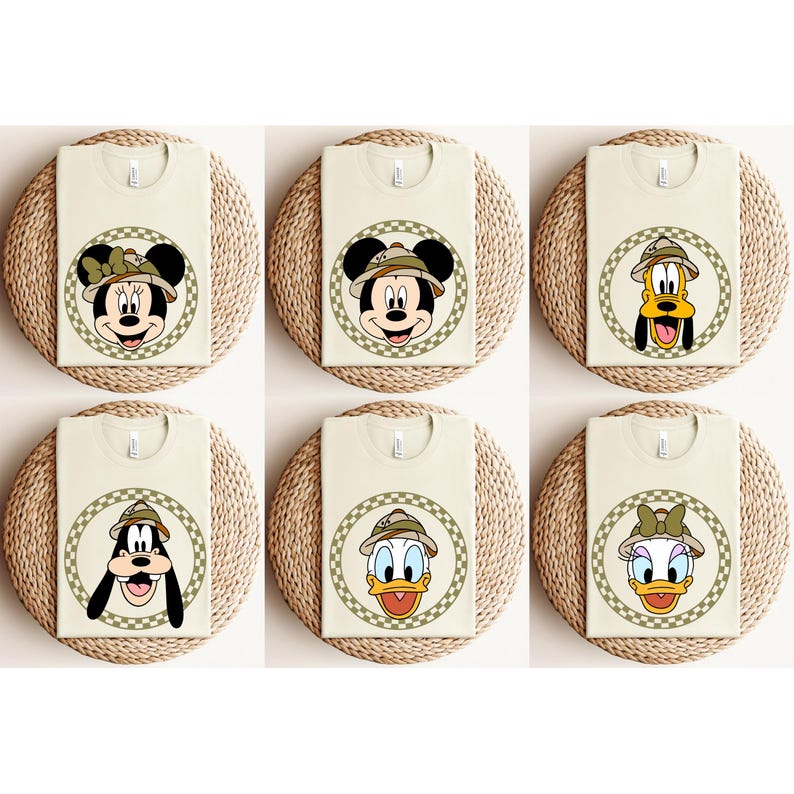 May include: Six beige t-shirts with different Disney characters wearing safari hats. The characters are Mickey Mouse, Minnie Mouse, Donald Duck, Goofy, Pluto, and Daisy Duck.