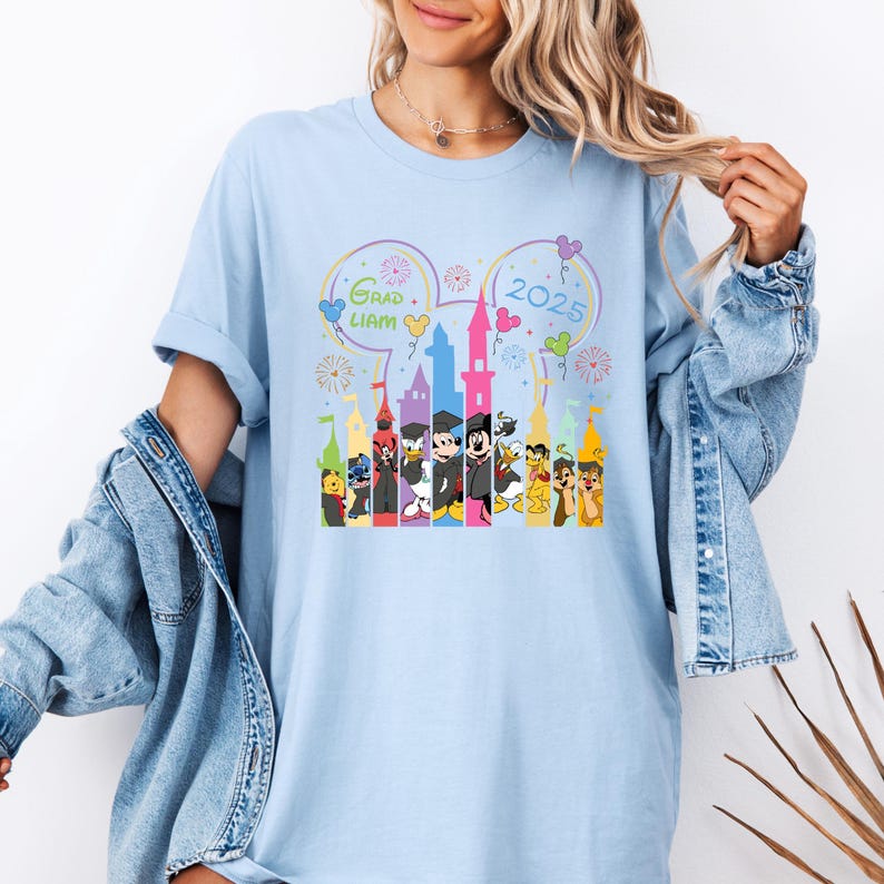 Puede incluir: Camiseta azul claro con un gr&aacute;fico de Mickey Mouse y otros personajes de Disney frente al Castillo de Cenicienta. El texto "Grad Liam 2025" est&aacute; en la camiseta.