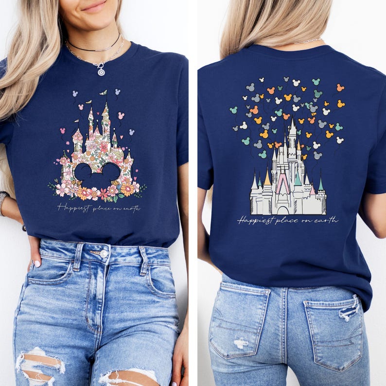 May include: A navy blue t-shirt with a floral print of Cinderella's castle and the text "Happiest place on earth". The back of the shirt features a white outline of Cinderella's castle with Mickey Mouse balloons.
