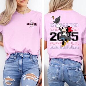 Puede incluir: Camiseta rosa con un gr&aacute;fico de un rat&oacute;n de dibujos animados con un gorro de graduaci&oacute;n y el texto "SENIOR 2025" en la parte posterior. La parte delantera de la camiseta tiene el texto "SENIOR 2025 Jessica".