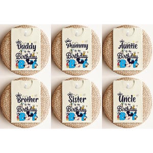 May include: Six beige t-shirts with a Mickey Mouse theme. Each shirt features a different family member title, such as "Daddy of the Birthday Boy", "Mommy of the Birthday Boy", "Auntie of the Birthday Boy", "Brother of the Birthday Boy", "Sister of the Birthday Boy", and "Uncle of the Birthday Boy".