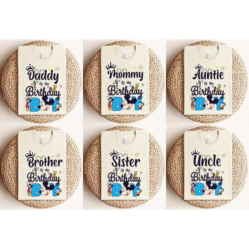 May include: Six beige t-shirts with a Mickey Mouse theme. Each shirt features a different family member title, such as "Daddy of the Birthday Boy", "Mommy of the Birthday Boy", "Auntie of the Birthday Boy", "Brother of the Birthday Boy", "Sister of the Birthday Boy", and "Uncle of the Birthday Boy".