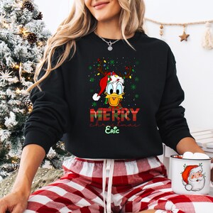 May include: A white ceramic mug with a black handle and the text "But First, Coffee" in a bold, black font. The mug is set against a neutral background, highlighting its simple design.