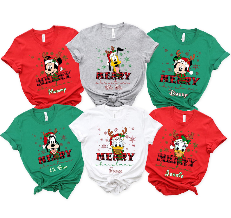 May include: Six red, green, white, and gray t-shirts with a Christmas theme. Each shirt features a different Disney character, including Mickey Mouse, Pluto, and Donald Duck. The shirts have the text "Merry Christmas" and a personalized name on each shirt.