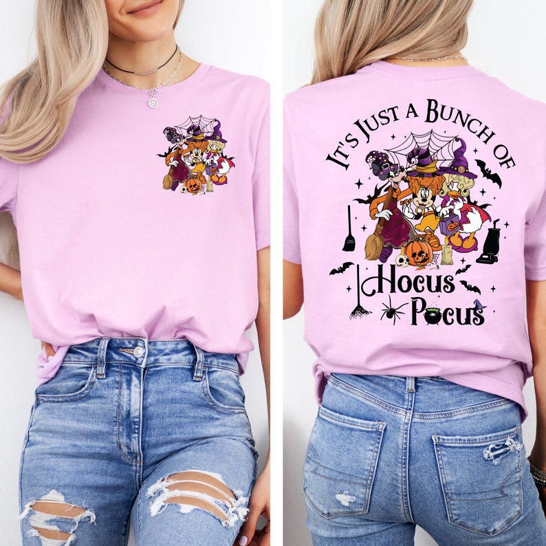 May include: A pink t-shirt with a graphic of Mickey Mouse, Minnie Mouse, Donald Duck, and Goofy dressed in Halloween costumes. The back of the shirt says "It's just a bunch of Hocus Pocus".