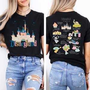May include: Black t-shirt featuring a colourful illustration of Disneyland castle on the front and a map of Disneyland attractions on the back. The text "Disneyland" is printed below the castle.