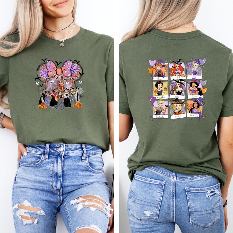 May include: Olive green t-shirt featuring a Halloween-themed graphic on the front with a bow, castle, and witch characters. The back of the shirt displays a grid of witch portraits. The shirt is paired with blue jeans.
