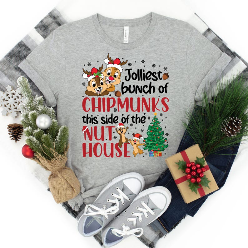 May include: A gray t-shirt with a Christmas-themed design featuring cartoon chipmunks and the text "Jolliest bunch of chipmunks this side of the nut house".