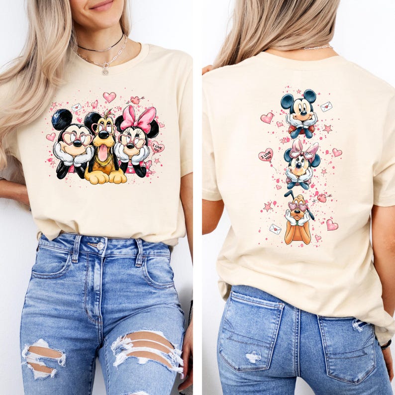 May include: A cream-colored t-shirt featuring a colorful graphic of Mickey Mouse, Minnie Mouse, and Pluto. The front design shows the characters with hearts and the words "I Love You". The back of the shirt has a vertical design of the characters.