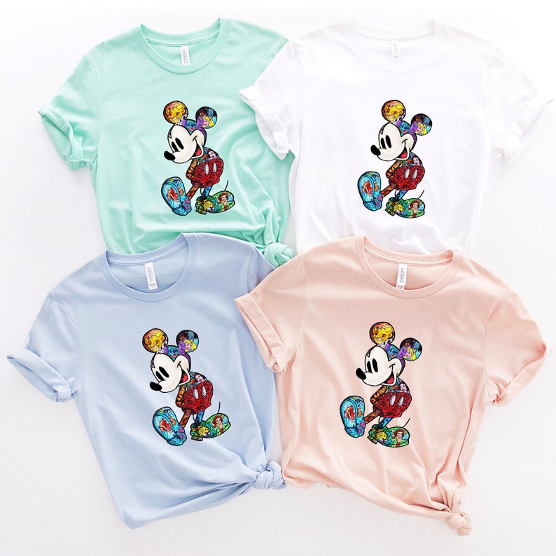 Puede incluir: Cuatro camisetas con un gr&aacute;fico de Mickey Mouse colorido. Las camisetas son de diferentes colores: azul claro, verde claro, blanco y rosa.