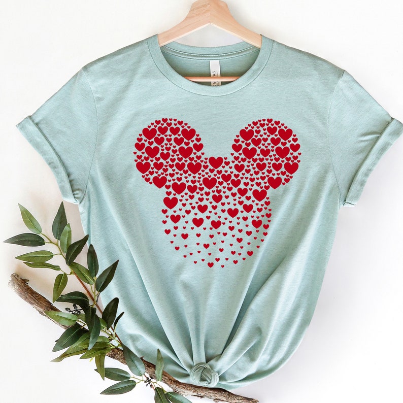 May include: A light blue t-shirt with a red Mickey Mouse head design made of hearts.