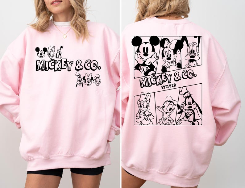 May include: Pink sweatshirt with a black graphic print of Mickey Mouse and friends. The print includes the text "Mickey & Co. Est. 1928".