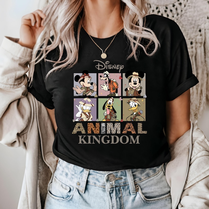 May include: Black t-shirt with a graphic of Disney characters dressed in safari outfits. The text "Disney Animal Kingdom" is printed below the graphic.