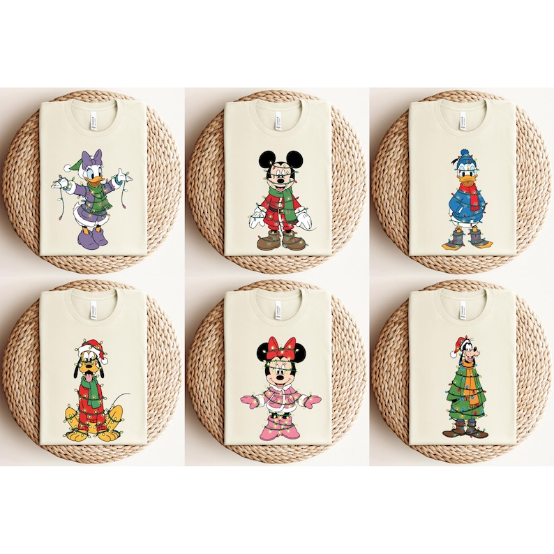 May include: Six cream-colored t-shirts featuring Disney characters in festive holiday attire. Characters include Mickey Mouse, Minnie Mouse, Donald Duck, Daisy Duck, Pluto, and Goofy, each adorned with Christmas lights and seasonal clothing.