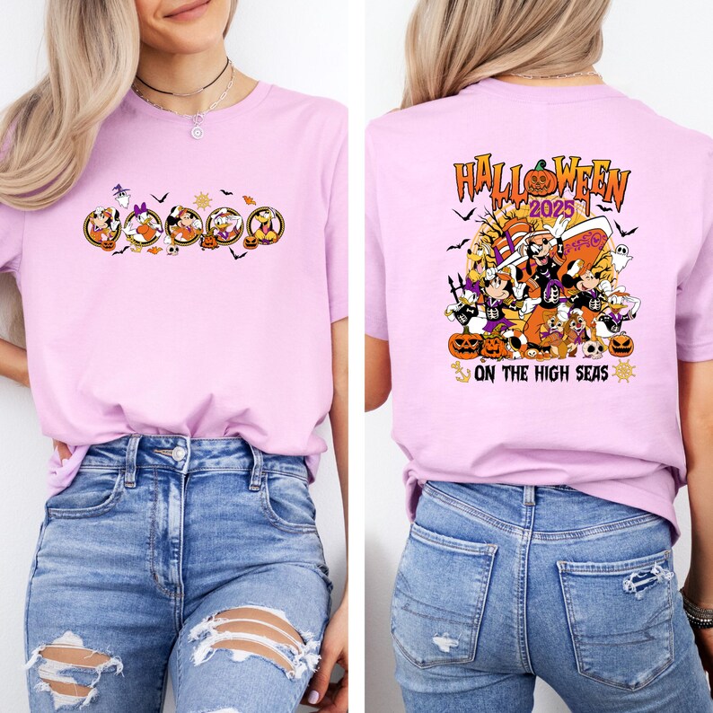 May include: A light pink t-shirt featuring a Halloween-themed graphic. The front of the shirt displays cartoon characters in oval frames. The back of the shirt has the text "Halloween 2025" with additional Halloween-themed illustrations.