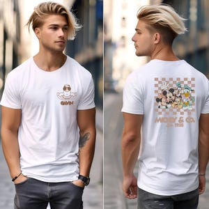 May include: White t-shirt with a brown graphic on the front of a person in a pool floatie and the name "GAVIN". The back of the shirt features a Mickey & Co. design with Mickey, Minnie, Donald, and Goofy. The text "Mickey & Co. Est. 1928" is also visible.