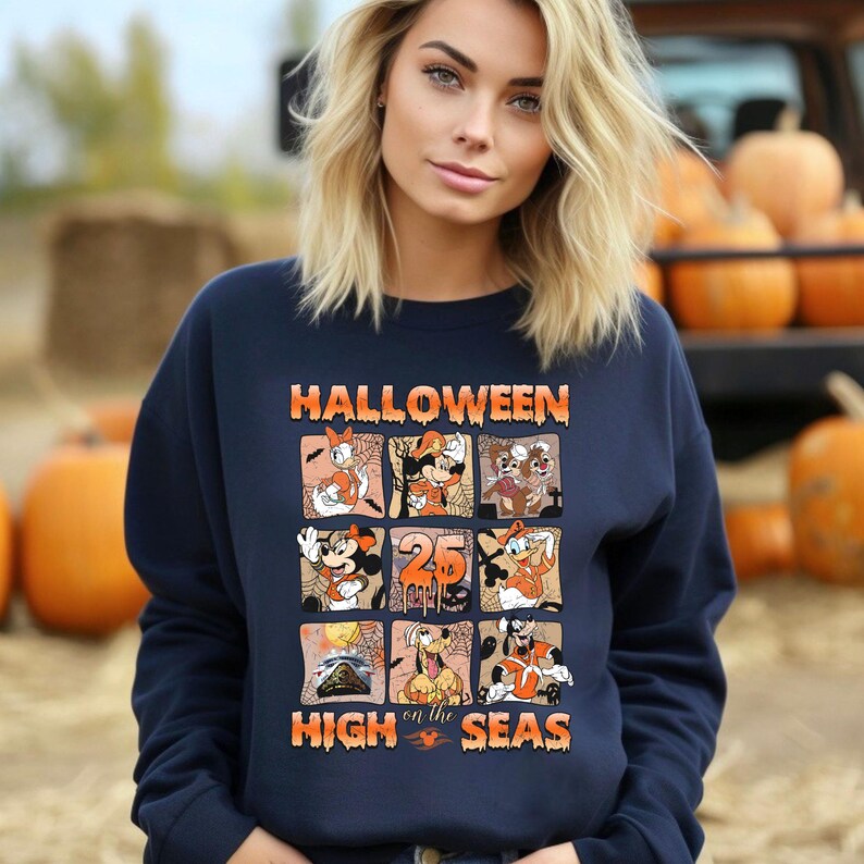 May include: A navy blue sweatshirt with a graphic print of Mickey Mouse and other Disney characters. The text "HALLOWEEN on the HIGH SEAS" is printed on the front of the sweatshirt.