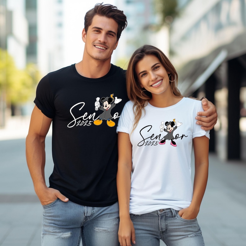 May include: Two people wearing black and white t-shirts with a Mickey Mouse and Minnie Mouse graduation design. The shirts say "Senior 2023".