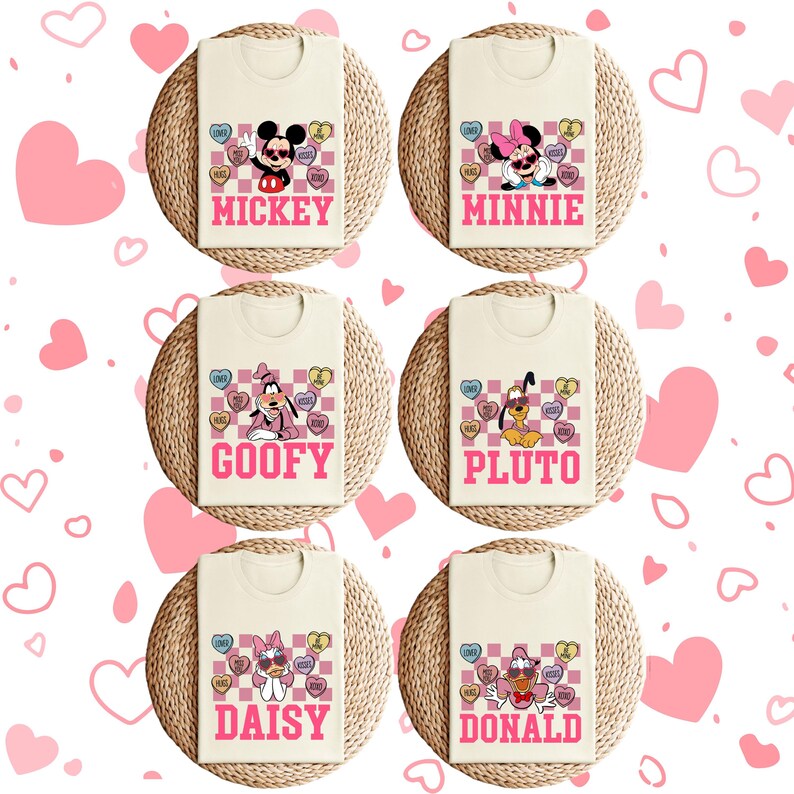 May include: Cream-colored t-shirts featuring Disney characters Mickey, Minnie, Goofy, Pluto, Daisy, and Donald. Each shirt has a character name in pink, a checkered background, and heart-shaped candies with phrases like "Love" and "Be Mine."