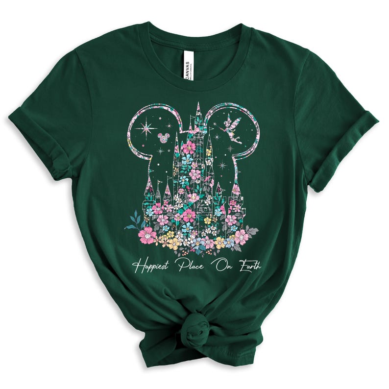 May include: A green t-shirt with a floral design of Cinderella's castle in the shape of Mickey Mouse ears. The text "Happiest Place On Earth" is printed below the design.