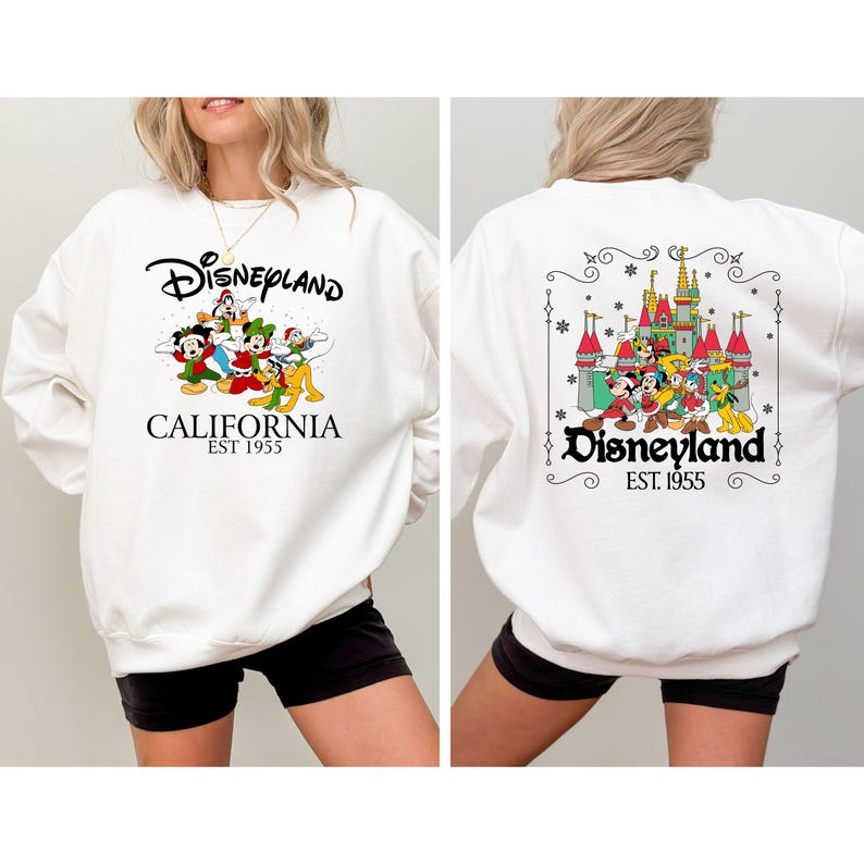 May include: White sweatshirt with a Disneyland California graphic on the front and back. The front graphic features Disney characters and the text "Disneyland California EST 1955". The back graphic shows a castle and Disney characters with the text "Disneyland EST 1955".