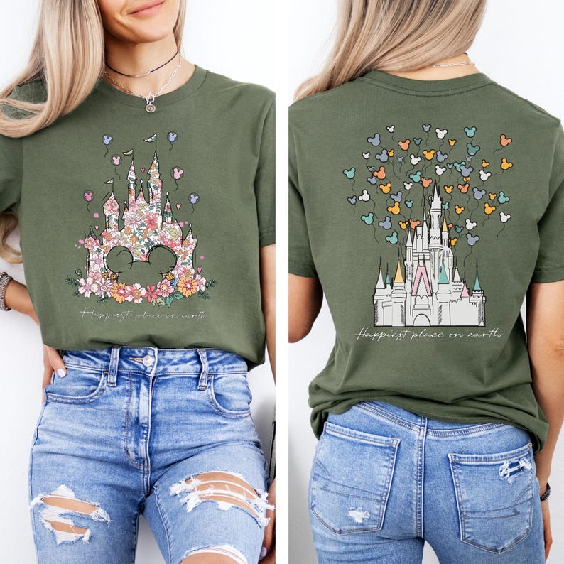 May include: A green t-shirt with a floral design of Cinderella's castle and the words "Happiest place on earth" on the front. The back of the shirt has a white outline of Cinderella's castle with colorful Mickey Mouse balloons.