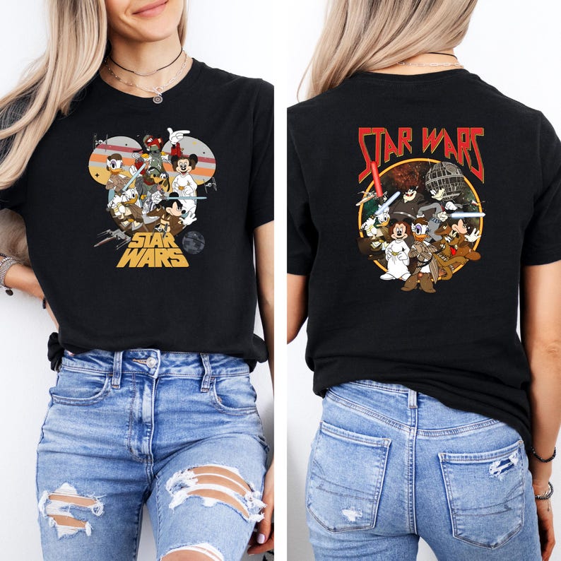 May include: Black t-shirt featuring a colorful graphic of Disney characters in Star Wars attire. The front design includes Mickey Mouse, Donald Duck, and Goofy. The back of the shirt has a similar design with the words "STAR WARS" in red.