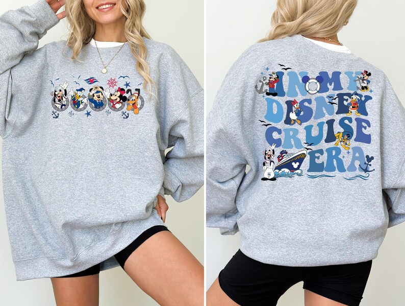 May include: Gray sweatshirt with a blue and white graphic of Disney characters and the text "In My Disney Cruise Era".