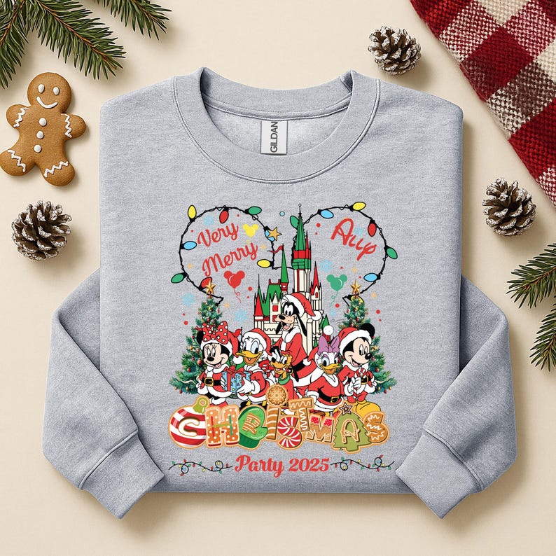 May include: A light gray sweatshirt with a festive Christmas design. The graphic features Disney characters in Santa outfits, a castle, and the words "Very Merry" and "All" in a Mickey Mouse ear shape. The text "Christmas Party 2025" is also included.
