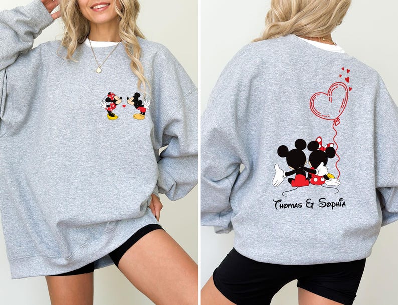 May include: Gray sweatshirt with a Mickey Mouse and Minnie Mouse graphic on the front and a heart with the text "Thomas & Sophia" on the back.