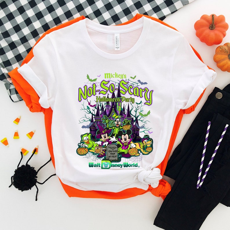 May include: White t-shirt with a graphic of Mickey Mouse and friends in front of a castle. The text "Mickey's Not-So-Scary Halloween Party" is printed on the shirt. The text "Walt Disney World" is printed at the bottom of the shirt.