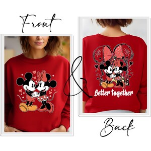May include: Red sweatshirt with a graphic of Mickey Mouse and Minnie Mouse holding hands. The back of the sweatshirt has a larger graphic of Mickey and Minnie with fireworks and the text "Better Together".