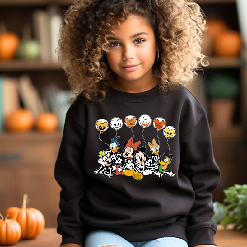 May include: Black sweatshirt with a graphic of Mickey Mouse and friends dressed as skeletons holding balloons. The balloons are shaped like Mickey Mouse heads and are orange, yellow, green, and purple.
