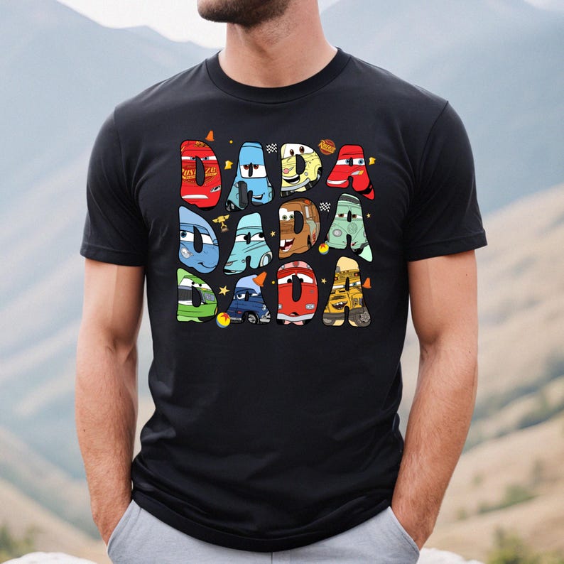 May include: Black t-shirt with a graphic of the word "DADA" spelled out with cartoon cars from the movie Cars.