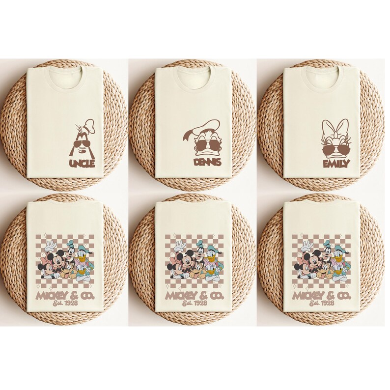 May include: Cream-colored t-shirts with brown graphics of Disney characters and names. The top row features "UNCLE", "DENNIS", and "EMILY". The bottom row displays a group graphic with "MICKEY & CO. Est. 1928".