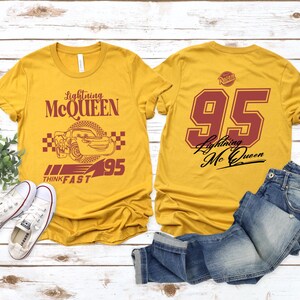 May include: Two yellow t-shirts with a Cars theme. One shirt features Lightning McQueen with the text "Lightning McQueen", "Think Fast", and "95". The other shirt has the number "95" and the text "Lightning McQueen".
