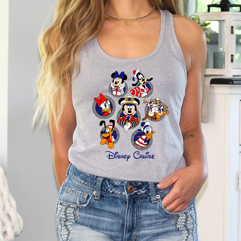 May include: A gray tank top featuring a colorful graphic of Disney characters, including Mickey Mouse, Minnie Mouse, Donald Duck, and Goofy. The text "Disney Cruise" is printed below the characters in blue. The tank top is sleeveless.