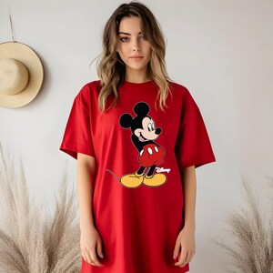 K&ouml;nnte beinhalten: &Uuml;bergr&ouml;&szlig;en-T-Shirt in Rot mit einem Cartoon-Bild von Mickey Mouse und dem darunter gedruckten Wort "Disney".