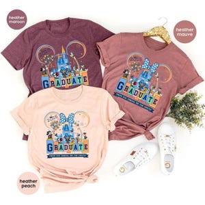 May include: Three t-shirts with a Disney theme featuring Mickey Mouse ears, Cinderella's castle, and the text "2025 GRADUATE FROM THE YASUEL TO THE CASTLE". The shirts are in heather maroon, heather peach, and heather mauve.