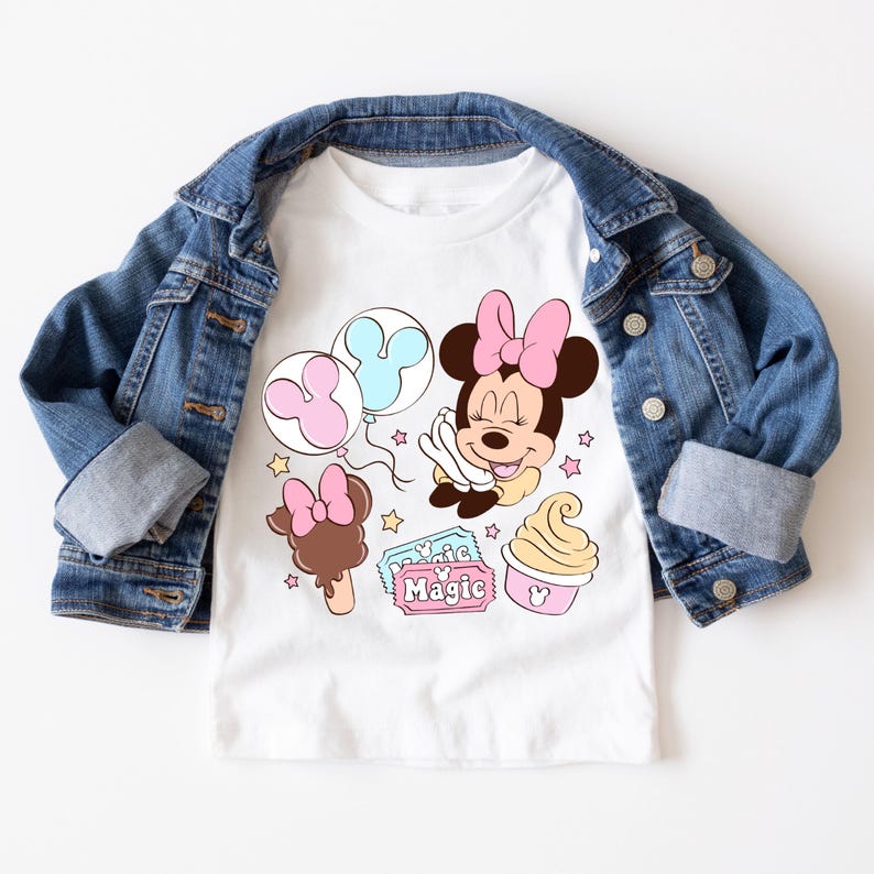May include: White t-shirt with a cartoon image of Minnie Mouse with balloons, ice cream, and a ticket that says "Magic".