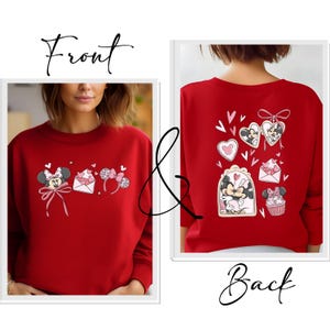 May include: Red sweatshirt featuring Minnie Mouse and Valentine's Day themed graphics. The front displays Minnie with a bow, an envelope, and mouse ear headbands. The back shows Minnie Mouse with hearts and a cupcake.