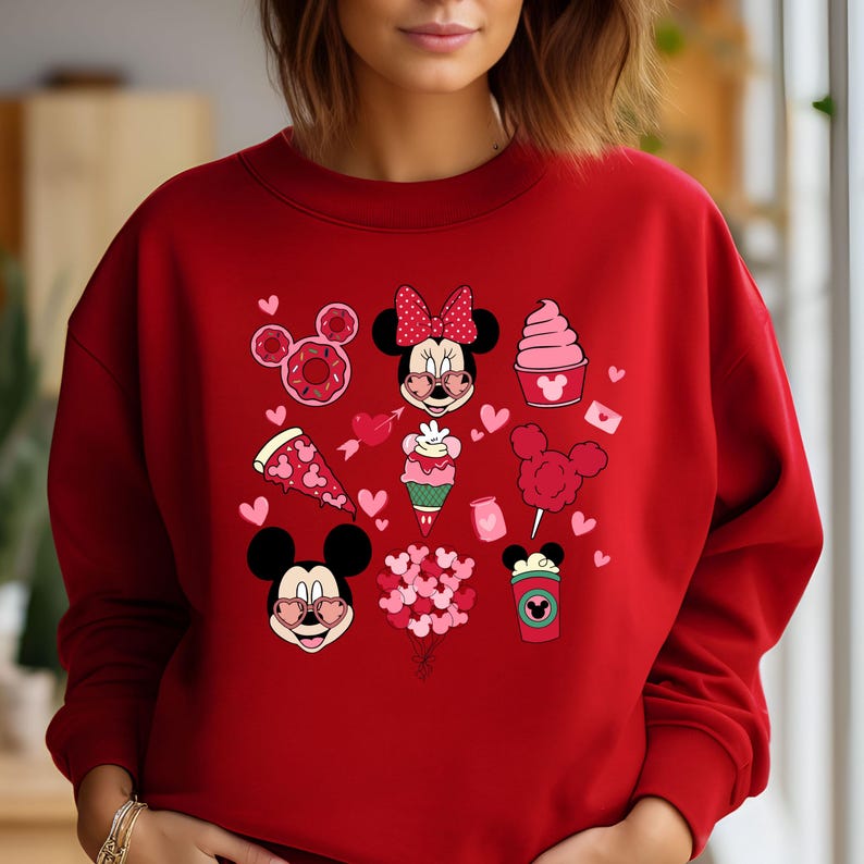May include: Red sweatshirt with a Valentine's Day theme featuring Mickey and Minnie Mouse, hearts, donuts, pizza, ice cream, and a coffee cup.
