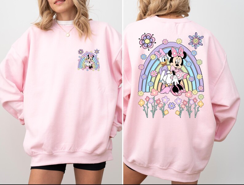 May include: Pink sweatshirt with a rainbow and Mickey Mouse and Minnie Mouse graphic on the back. The front of the sweatshirt has a smaller version of the graphic.