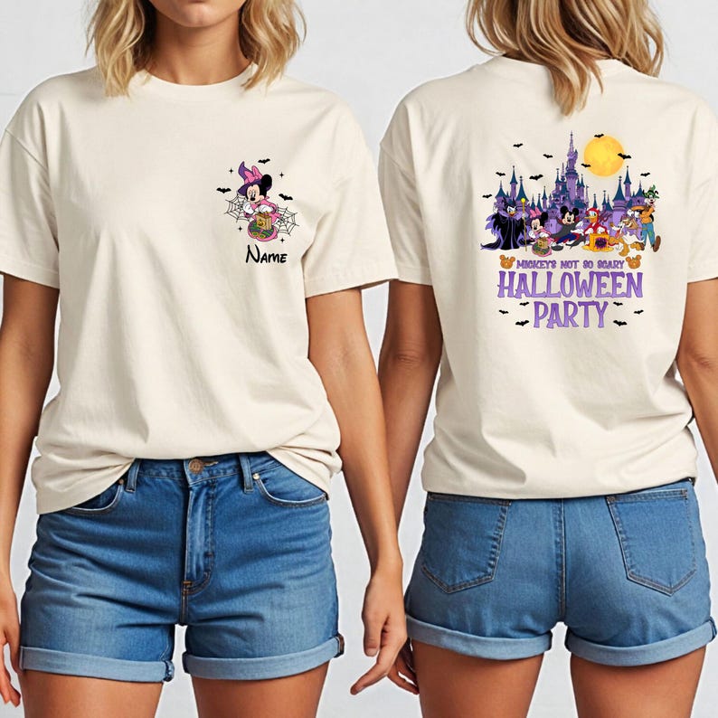 May include: Off-white t-shirt with a Halloween theme. The front features a Minnie Mouse graphic with a spider web and the name "Name". The back displays a castle, characters, and the text "Mickey's Not So Scary Halloween Party".