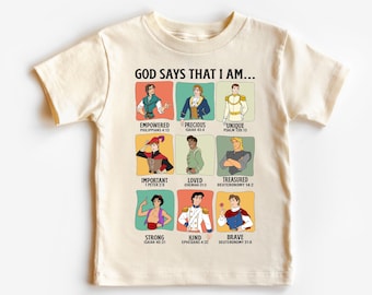 May include: A beige t-shirt with a graphic print of Disney princes and bible verses. The text reads "God says that I am..." and lists words like "empowered", "precious", "unique", "important", "loved", "treasured", "strong", "kind", and "brave".